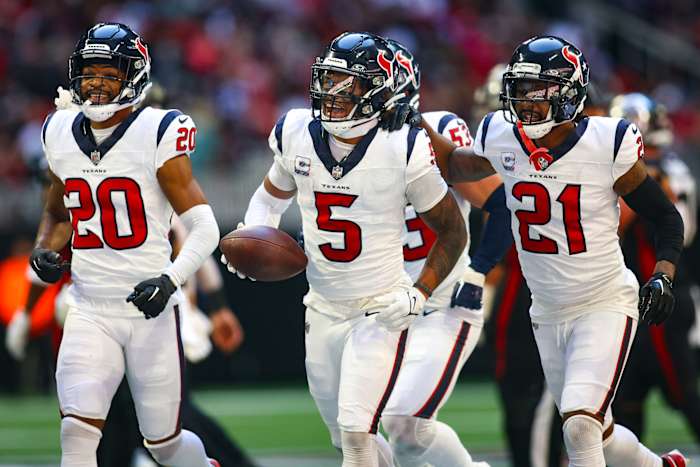 Houston Texans safety Jalen Pitre (5) celebrates with cornerback Ka'dar Hollman (20) and cornerback Steven Nelson (21) after a fumble recovery against the Atlanta Falcons in the second half at Mercedes Benz Stadium